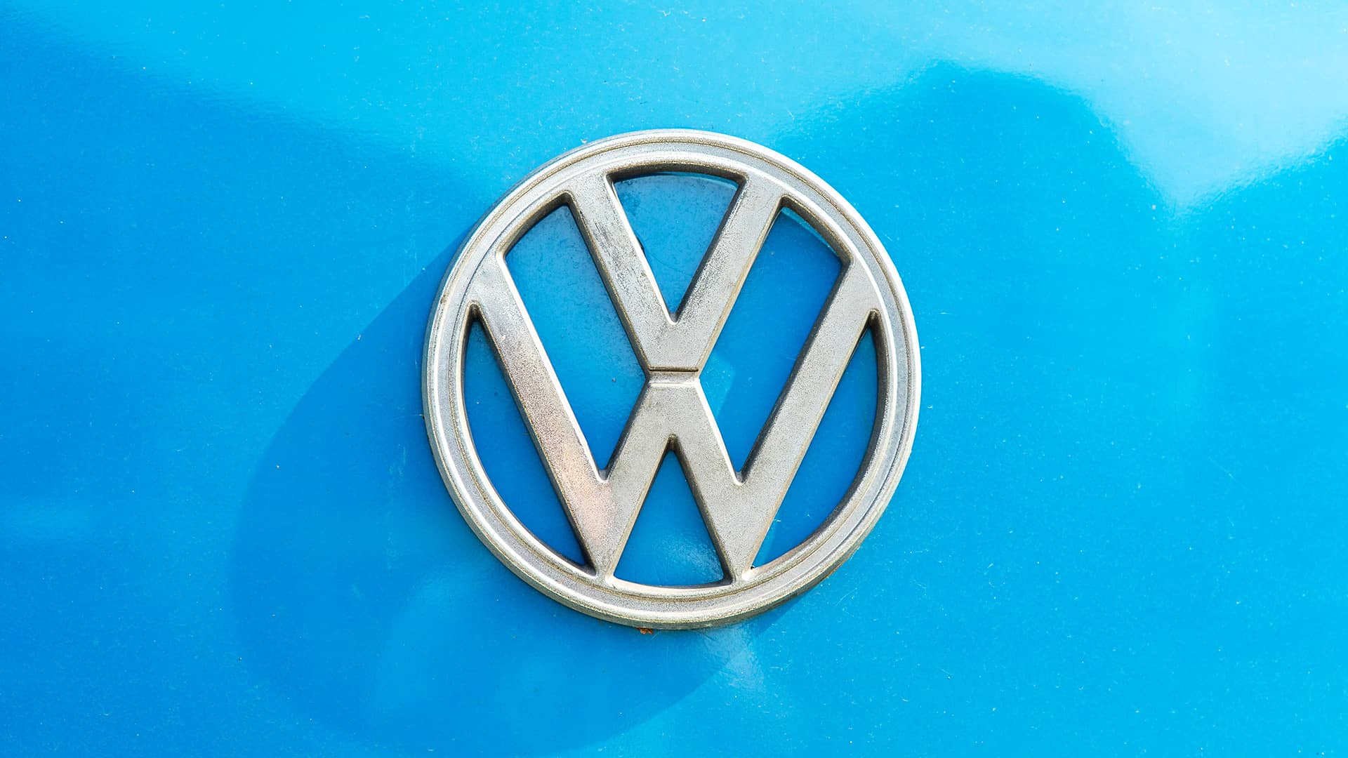 Close-up photo of the Volkswagen logo badge on a car.